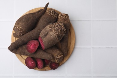 Whole and cut red beets on white table, top view. Space for text