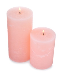 Photo of Burning pink wax candles on white background