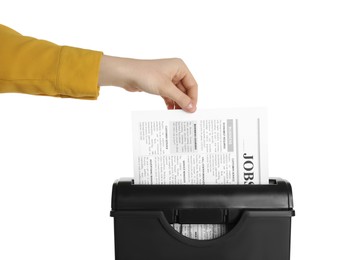 Photo of Woman destroying newspaper with paper shredder on white background, closeup