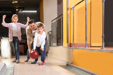 Photo of Happy family spending time together in bowling club