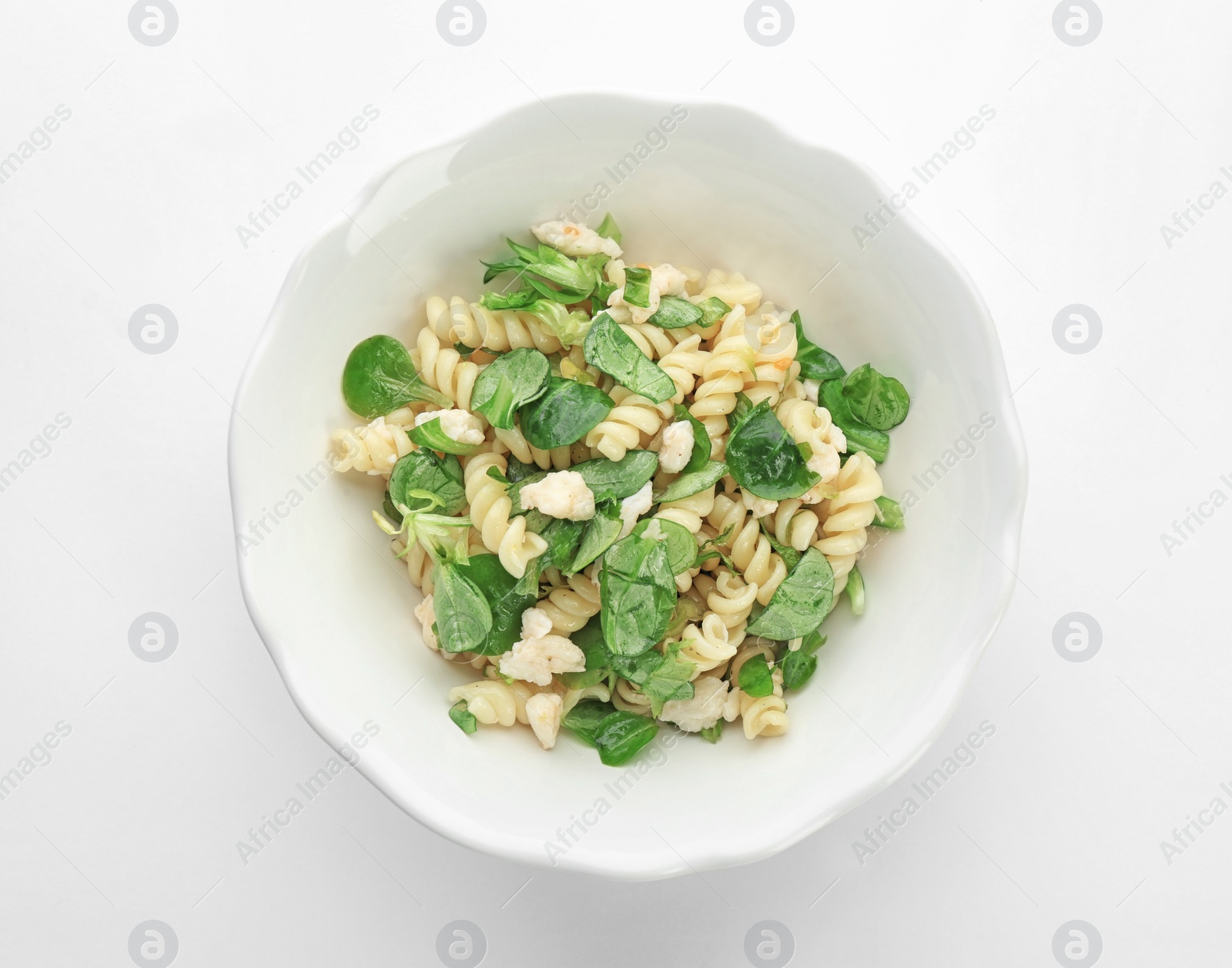 Photo of Tasty pasta salad with fresh herbs  on white background