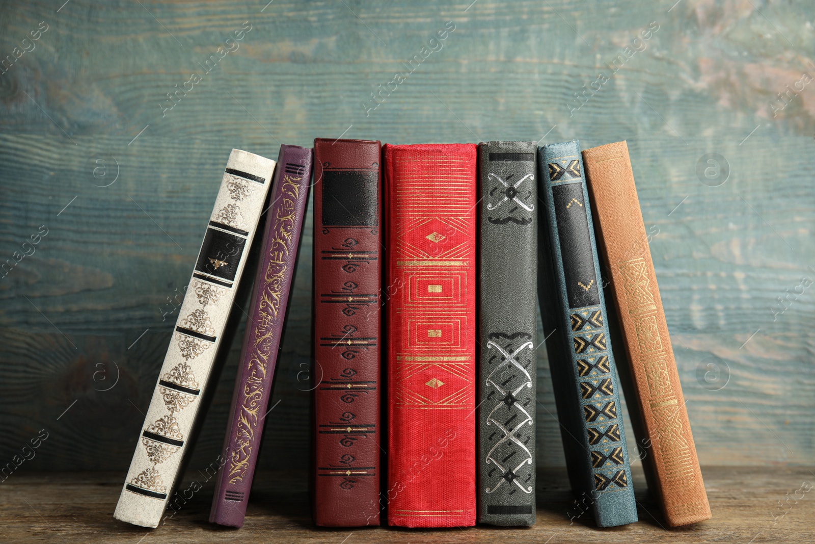 Photo of Collection of old books on wooden shelf