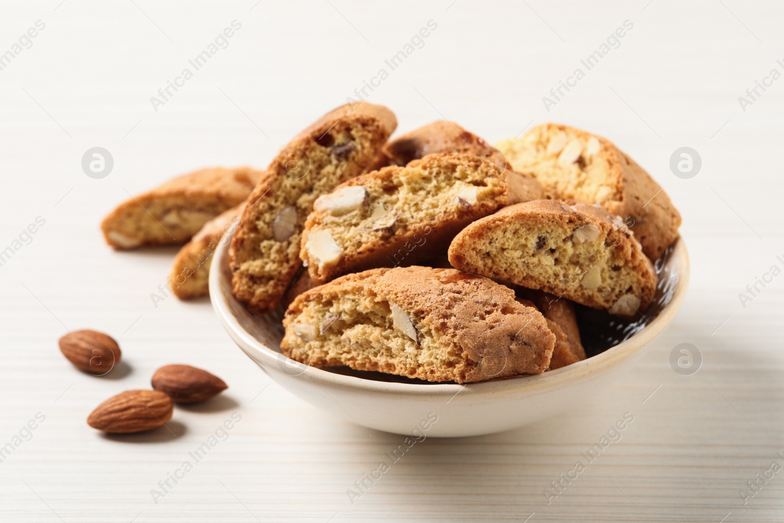 Photo of Traditional Italian almond biscuits (Cantucci) on white wooden table