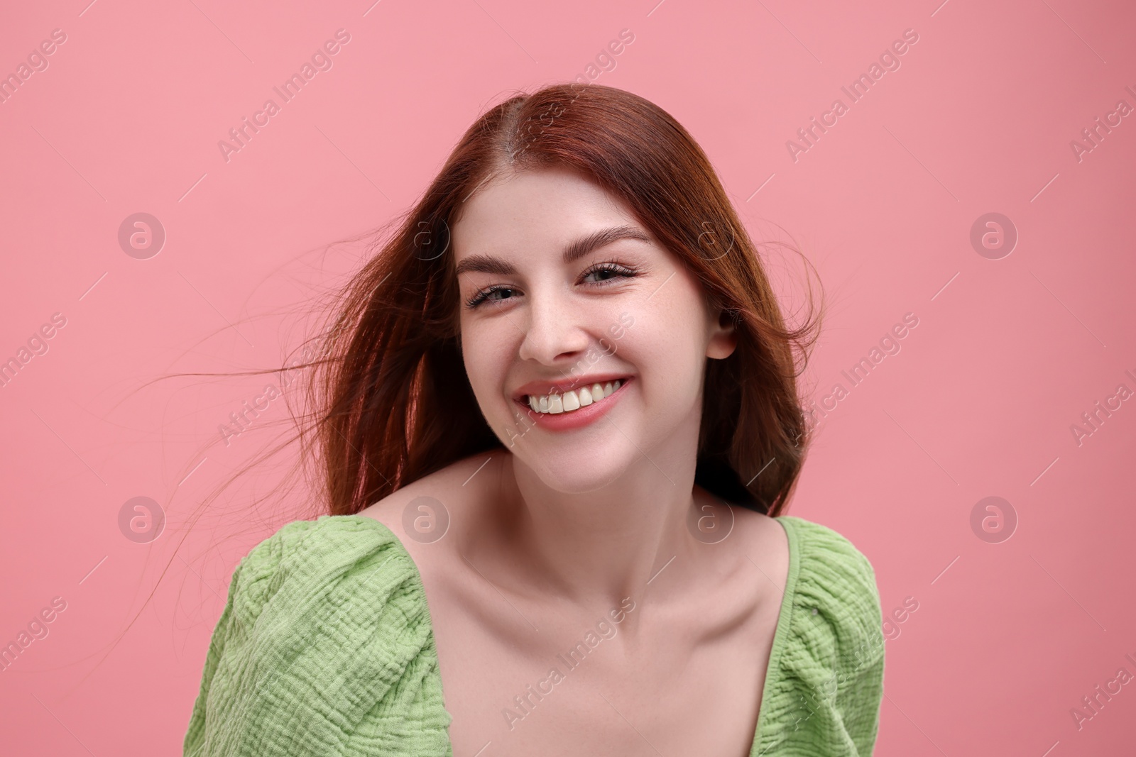 Photo of Portrait of smiling woman on pink background