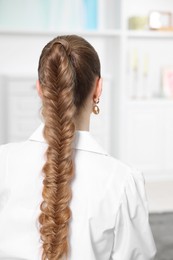 Photo of Woman with braided hair at home, back view
