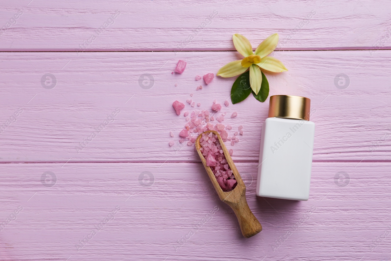 Photo of Flat lay composition with spa supplies on pink wooden table. Space for text