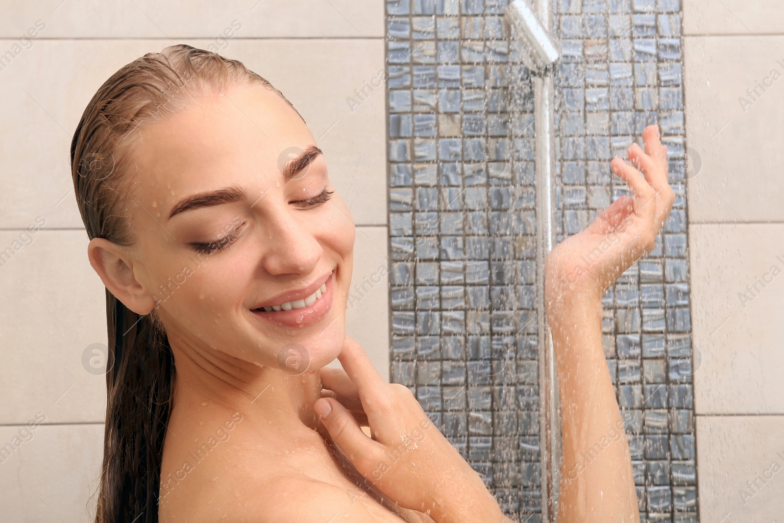 Photo of Beautiful young woman taking shower at home