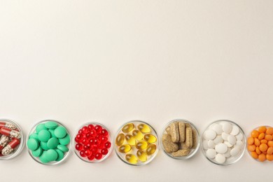 Photo of Different dietary supplements in bowls on white background, flat lay. Space for text