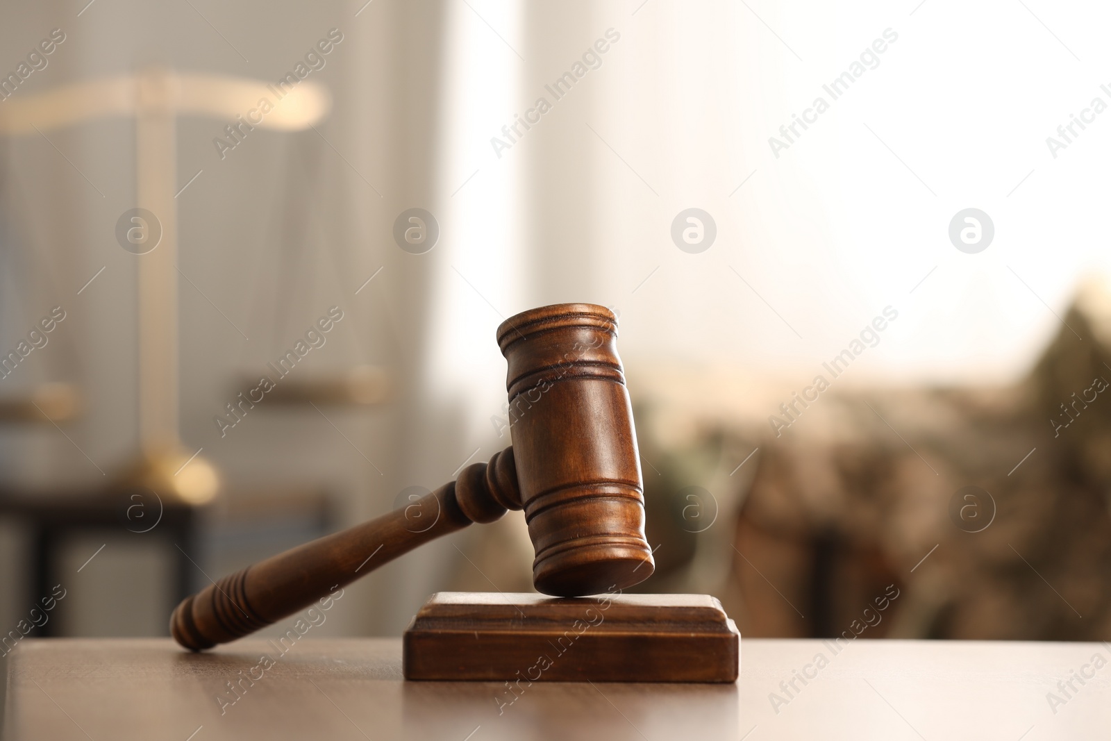 Photo of Law concept. Gavel on wooden table indoors