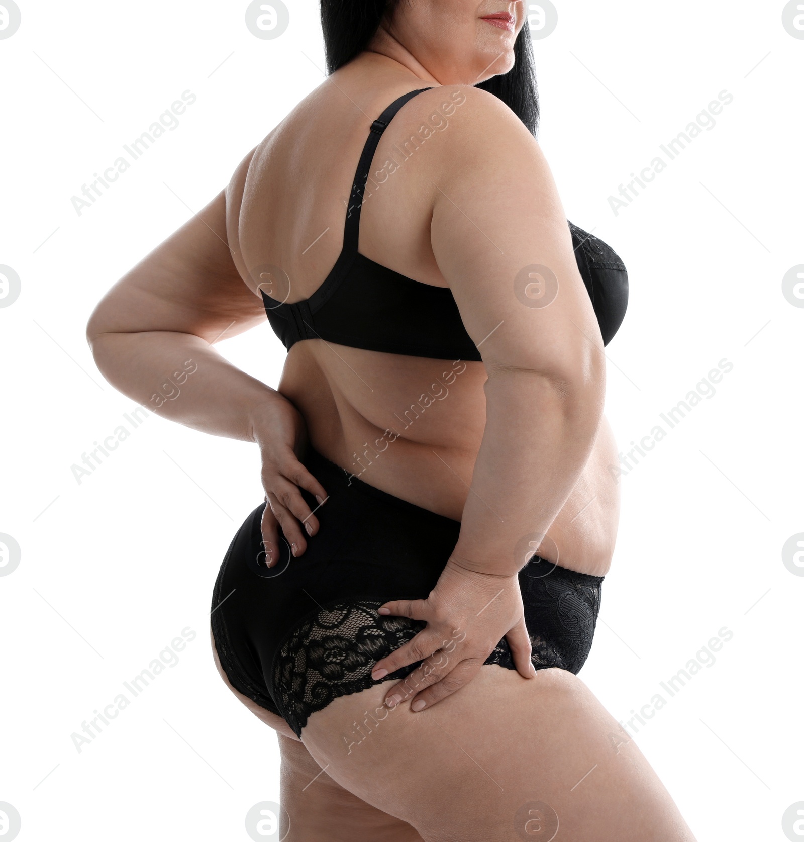 Photo of Overweight woman in black underwear on white background, closeup. Plus-size model