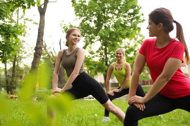 Photo of Women and teenage girl doing morning exercise in park