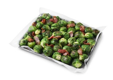 Delicious roasted Brussels sprouts and bacon in baking dish isolated on white