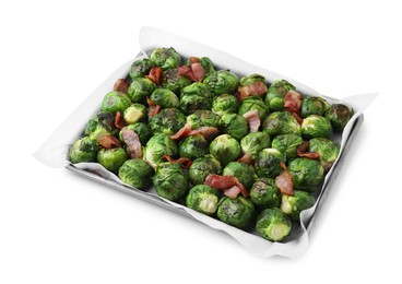 Photo of Delicious roasted Brussels sprouts and bacon in baking dish isolated on white