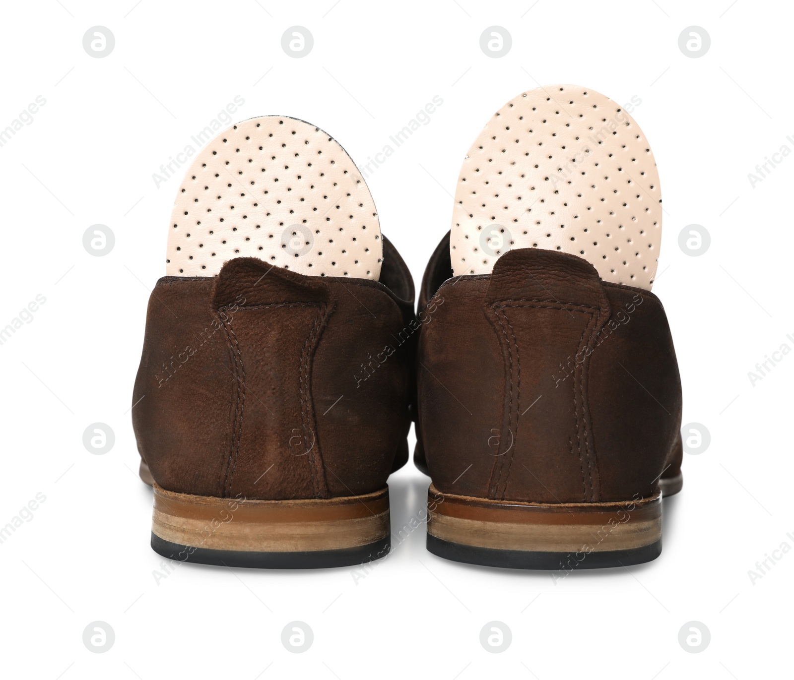 Photo of Orthopedic insoles in shoes on white background