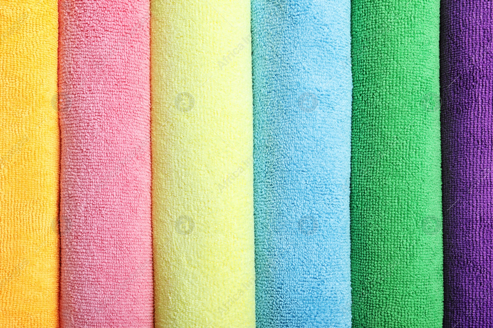 Photo of Many colorful microfiber cloths as background, top view