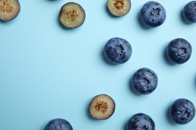 Photo of Flat lay composition with tasty blueberry and space for text on color background