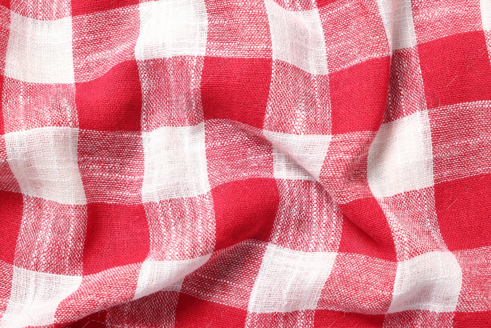 Photo of Texture of crumpled checkered fabric as background, top view