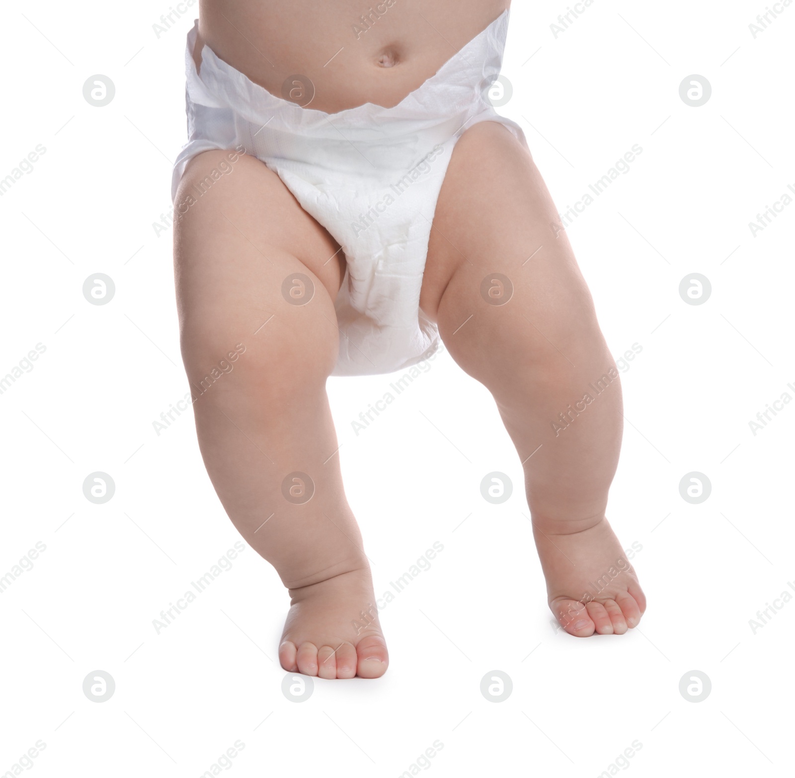 Photo of Cute baby in dry soft diaper standing on white background, closeup