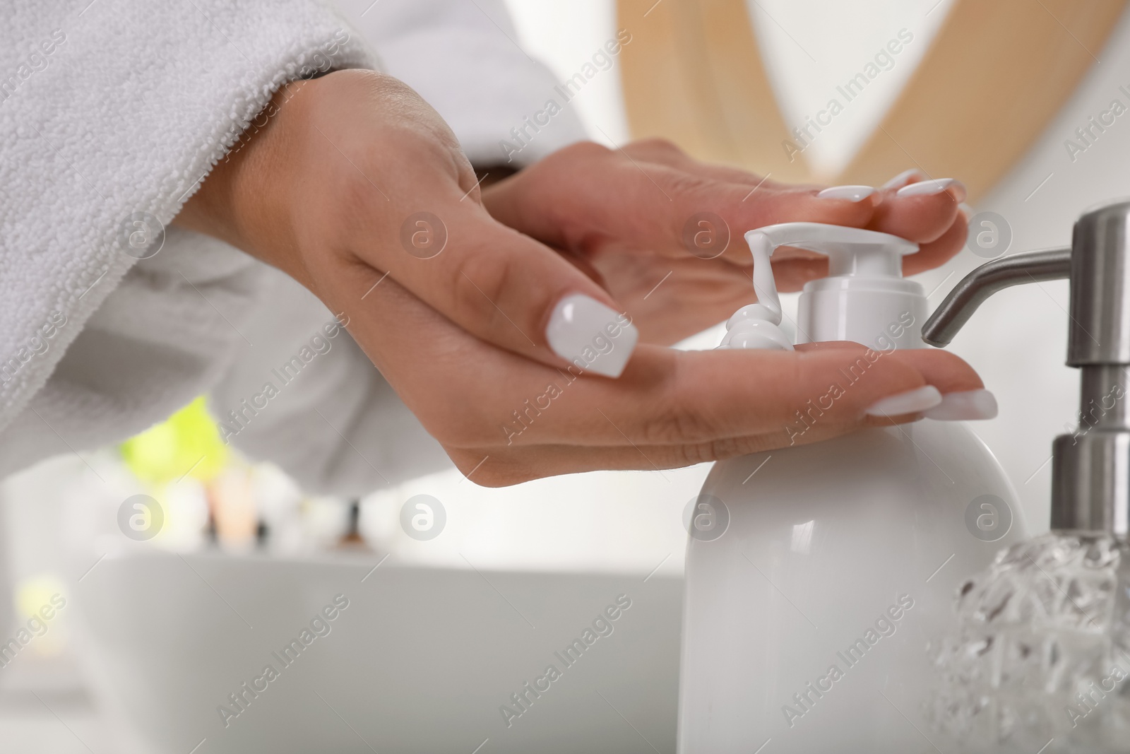 Photo of Teenage girl using gel in bathroom, closeup. Skin care cosmetic