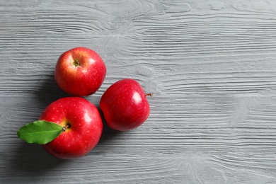 Fresh ripe red apples on wooden background