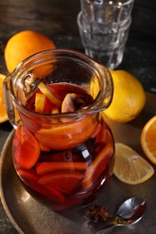 Photo of Jug of aromatic punch drink and ingredients on table