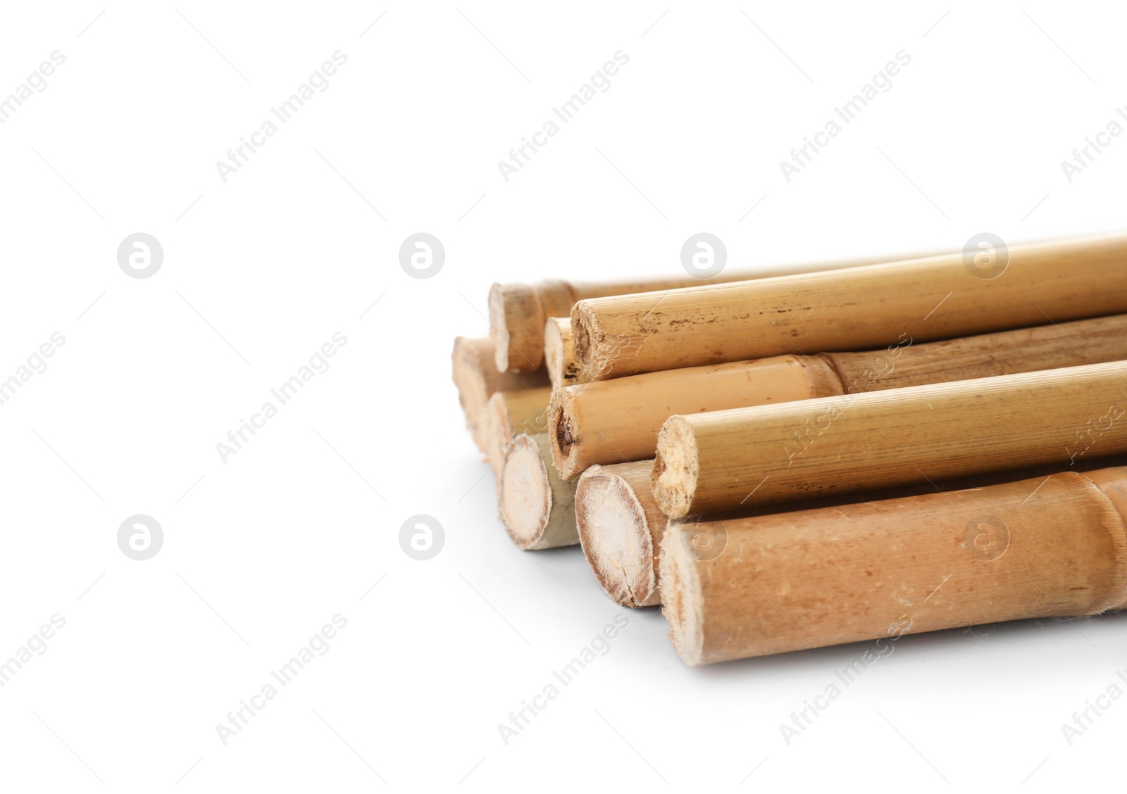 Photo of Pile of dry bamboo sticks on white background