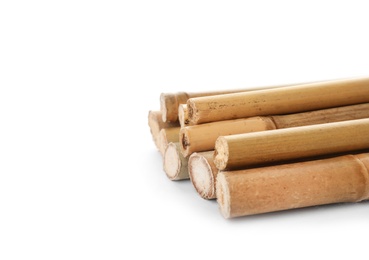 Pile of dry bamboo sticks on white background