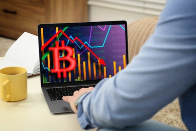 Image of Bitcoin collapse. Trader checking cryptocurrency rates on laptop at home, closeup