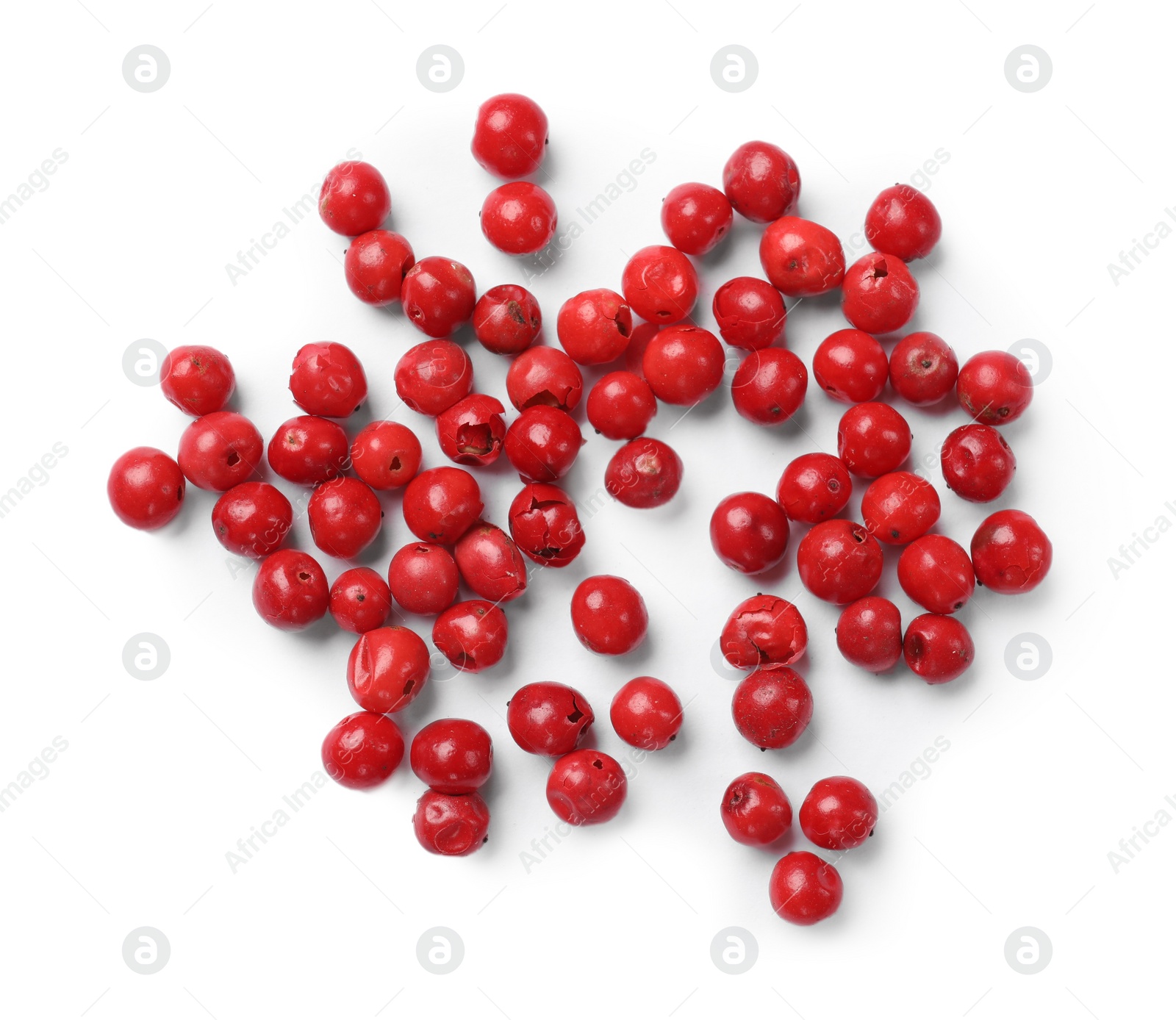 Photo of Aromatic spice. Many red peppercorns isolated on white, top view