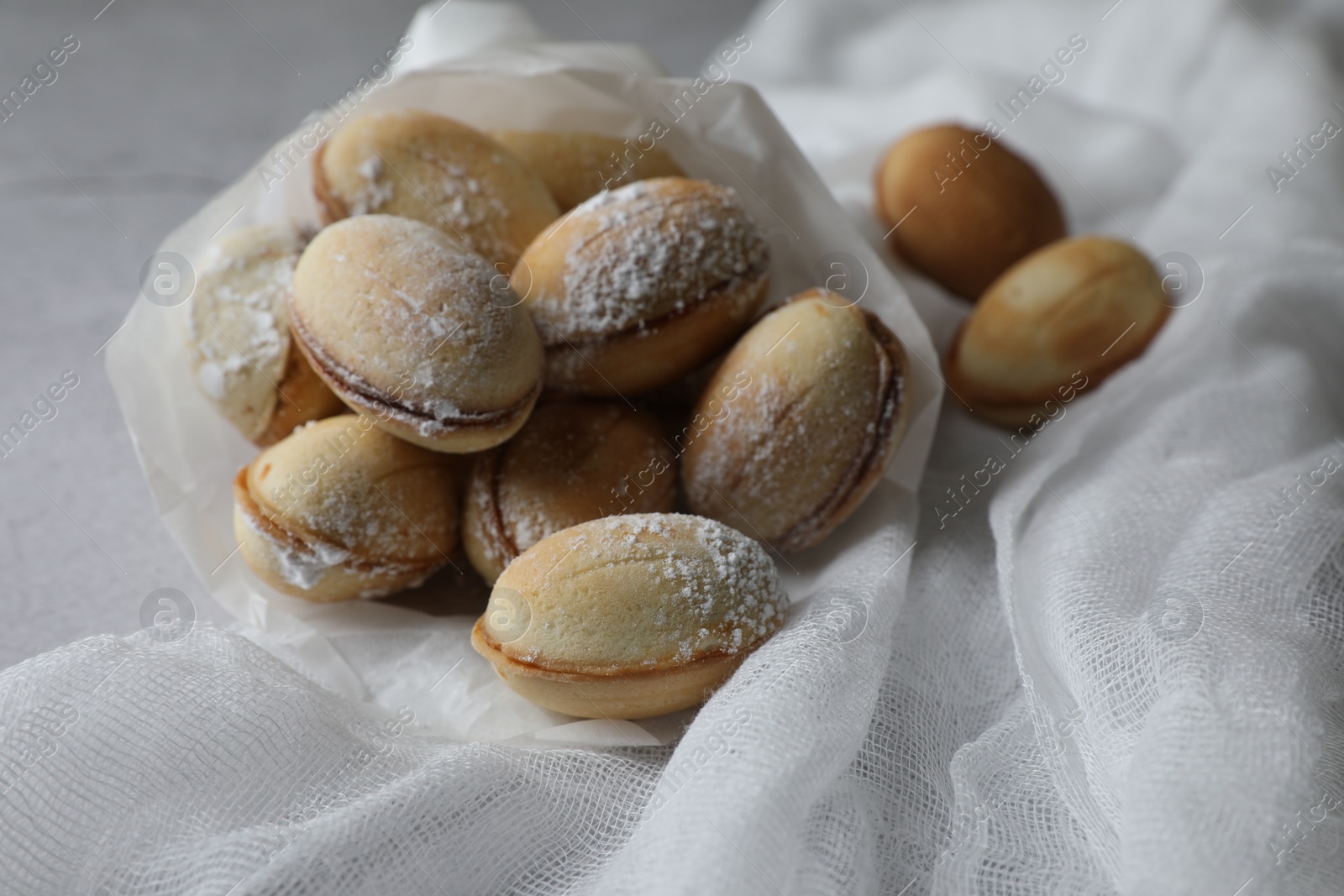 Photo of Delicious walnut shaped cookies with condensed milk on table, closeup