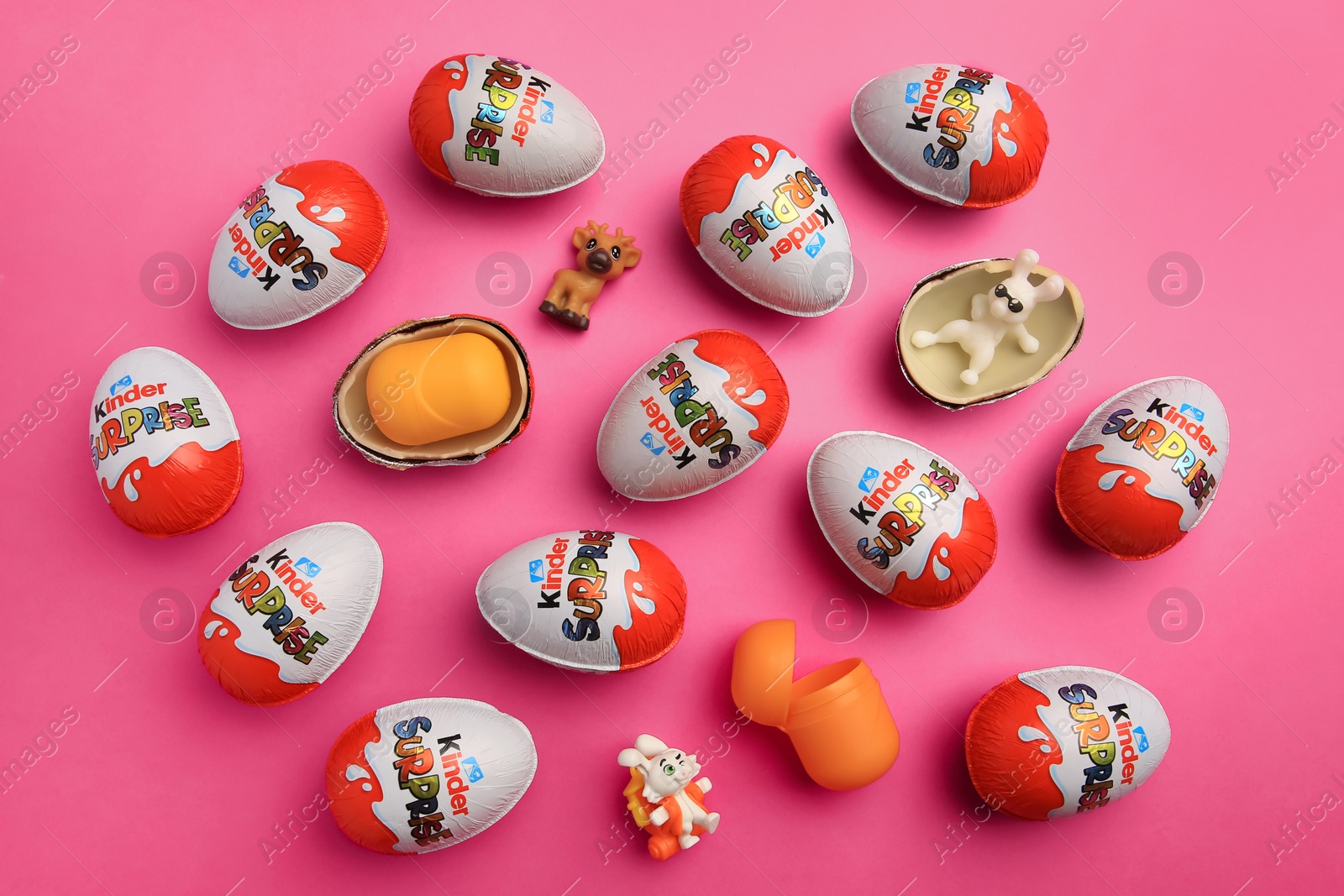 Photo of Sveti Vlas, Bulgaria - June 26, 2023: Kinder Surprise Eggs, plastic containers and toys on pink background, flat lay