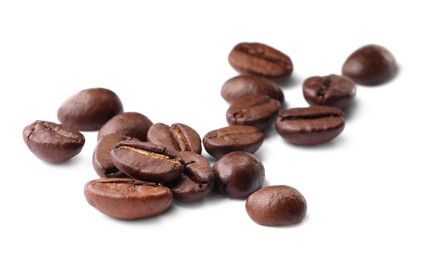 Photo of Many roasted coffee beans isolated on white