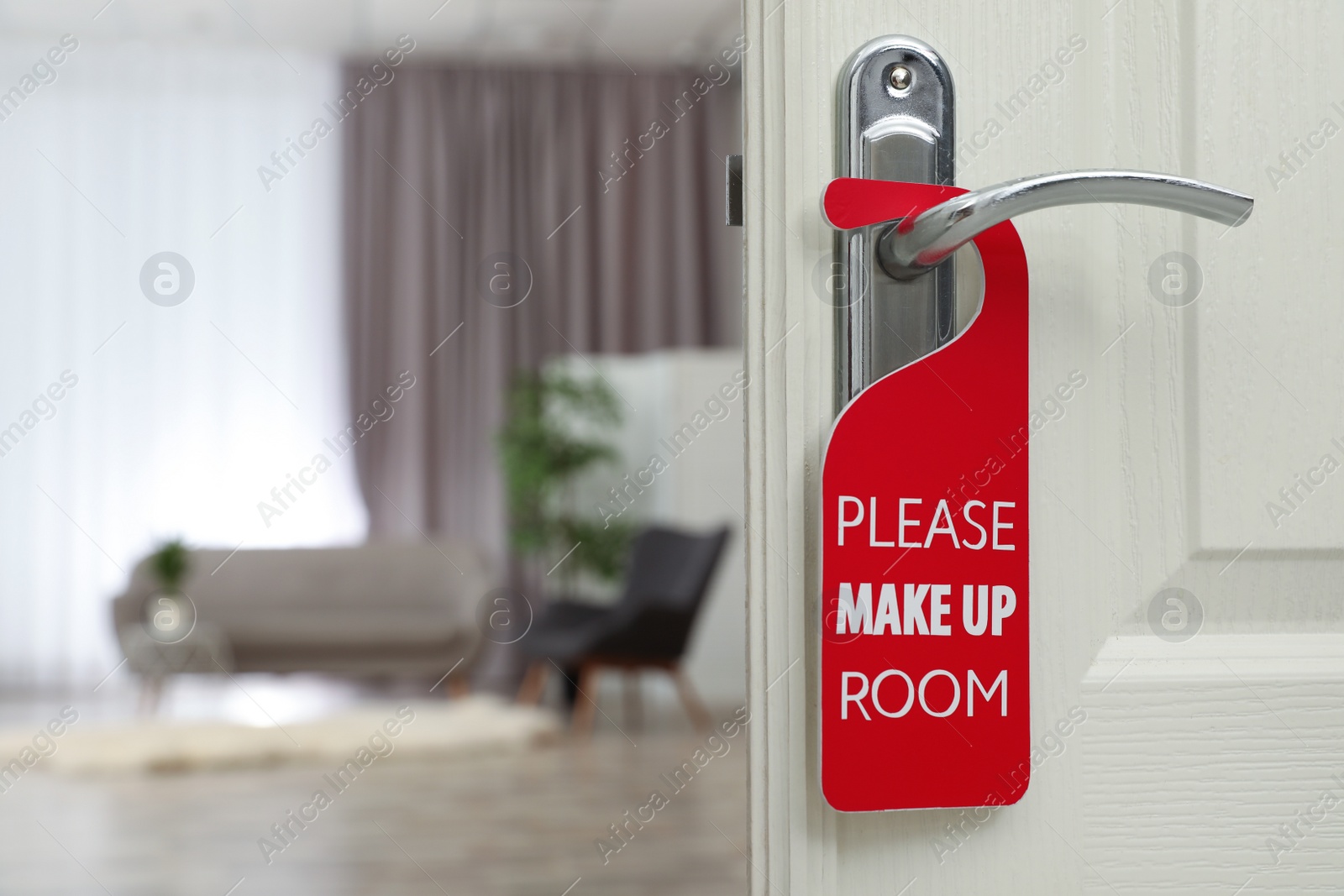 Photo of Open door with sign PLEASE MAKE UP ROOM on handle at hotel, space for text