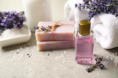 Photo of Cosmetic products and lavender flowers on light table