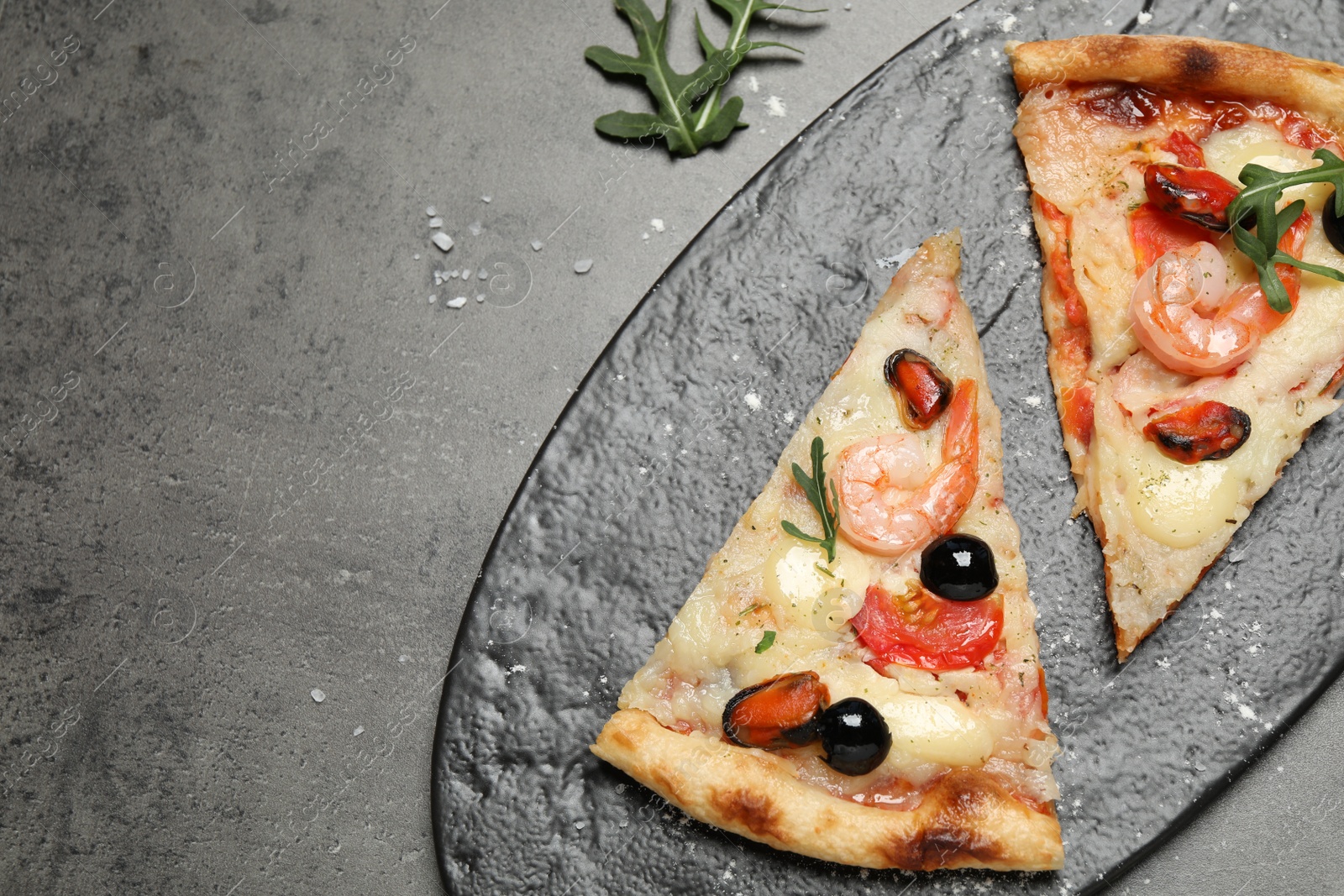 Photo of Tasty pizza with seafood and ingredients on grey table, flat lay. Space for text