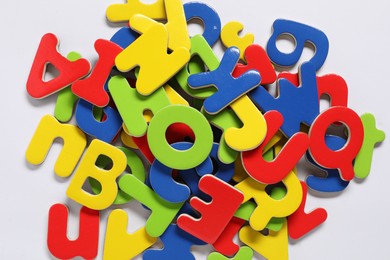 Learning alphabet. Bright magnetic letters on white background, top view