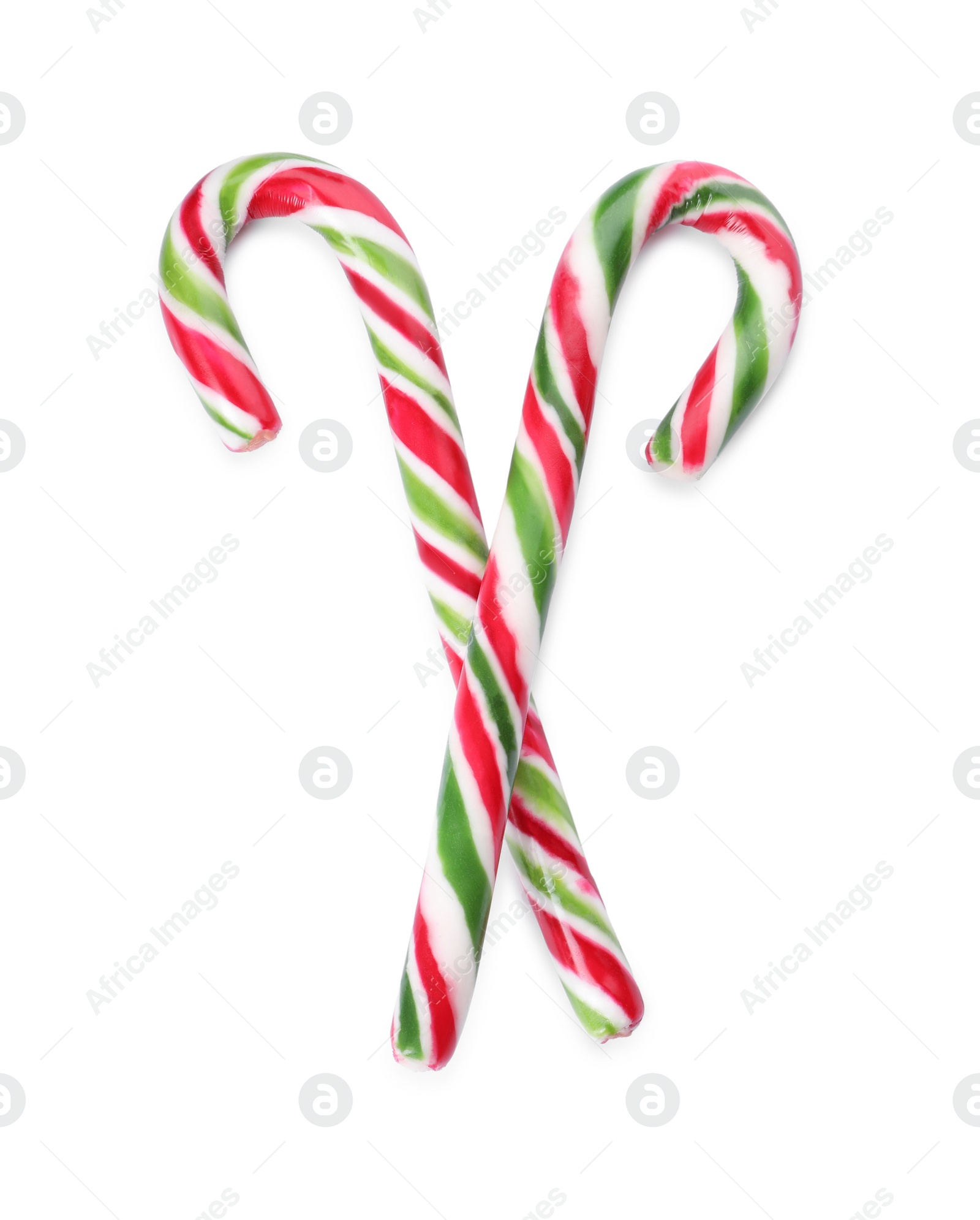 Photo of Sweet Christmas candy canes on white background