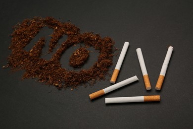 Photo of Word No made of tobacco and cigarettes on black table, closeup. Stop smoking concept
