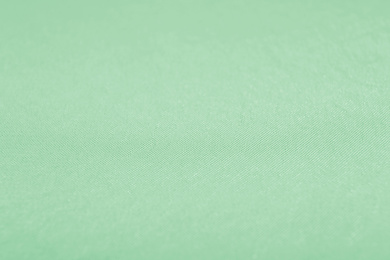 Texture of fabric as background. Image toned in mint color 