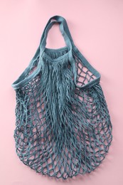 Photo of Blue string bag on pink background, top view