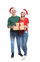 Photo of Young couple with Christmas gifts on white background