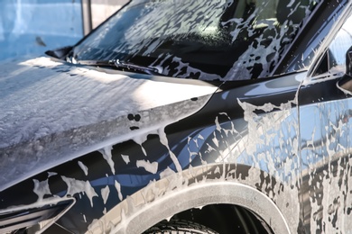 Automobile covered with foam at car wash