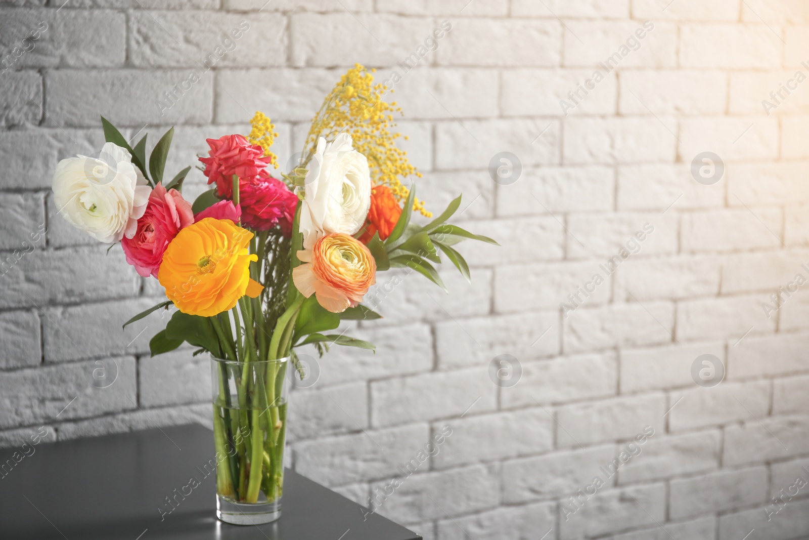 Vase with beautiful ranunculus flowers indoors Photo of Vase with beautiful ranunculus flowers indoors