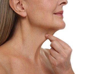 Mature woman touching her neck on white background, closeup