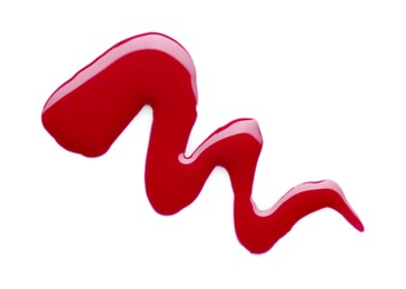 Photo of Sample of crimson nail polish isolated on white, top view