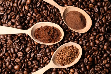 Photo of Spoons with different types of coffee on roasted beans, flat lay