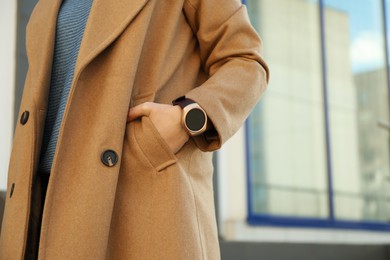 Photo of Mature woman with smart watch outdoors, closeup