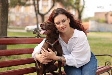 Photo of Woman with her cute German Shorthaired Pointer dog outdoors