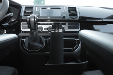 Photo of Black thermos in holder inside of car