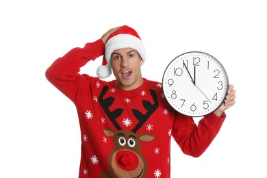 Photo of Man in Santa hat with clock on white background. New Year countdown